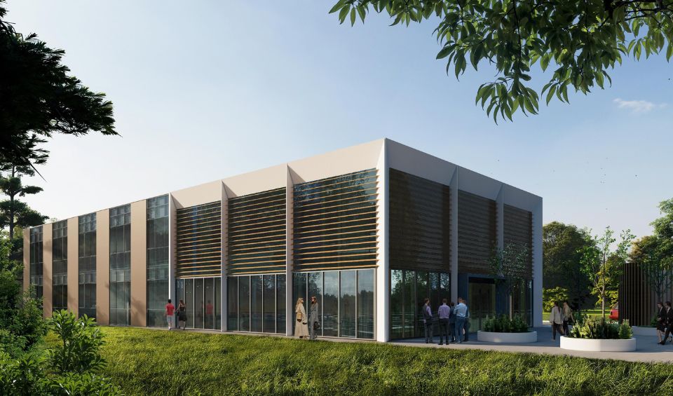A modern building with a sleek design, featuring large windows that provide ample natural light, set against a picturesque backdrop of mature trees and vibrant greenery.